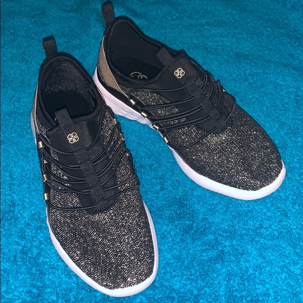 Gold and black tennis shoes